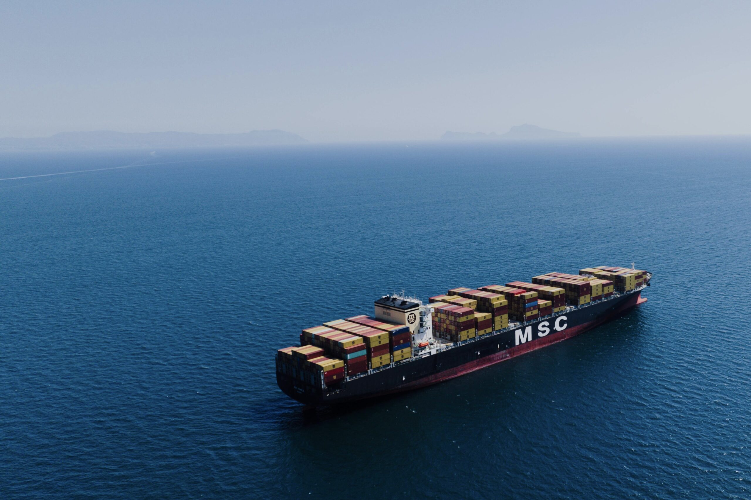 a cargo ship in the blue ocean